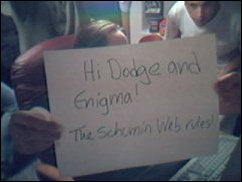 My handwriting, and Erin's holding the sign.  Another person ICQ-ed me with a request, and so we said okay.  Only one thing we changed... they wanted us to say "Spinnwebe", but we decided to say "The Schumin Web".